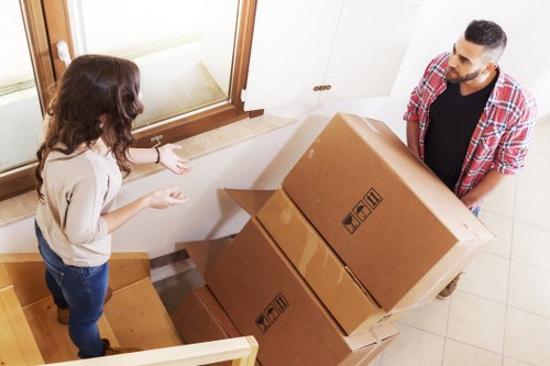 Trained removals staff using safe lifting techniques in Wimbledon