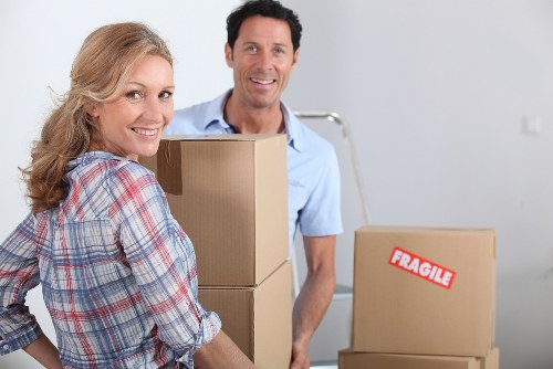 Household items being prepared for transport with a moving truck in Wimbledon